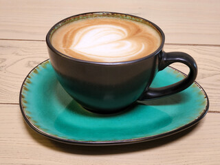 Ceramic cup green. Brewed coffee in a green cup