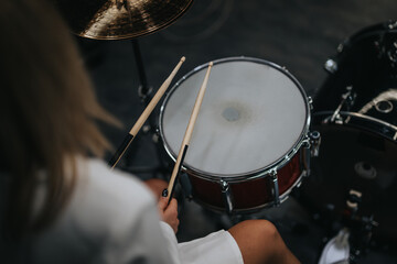 A musician performing on a drum set in a professional studio environment, showcasing musical...