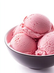 Pink ice cream scoops in a bowl on a white background.