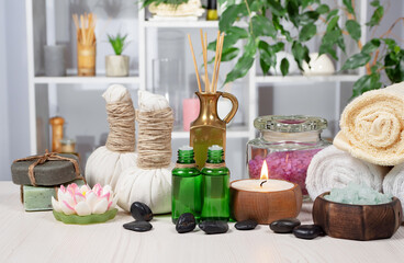 Spa massage items are arranged in a composition on the table.