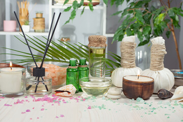 Spa items are arranged in a composition on a table.