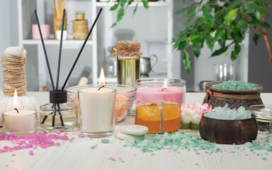 Spa items are arranged in a composition on a table.