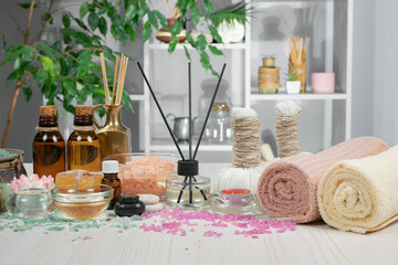 Spa massage items are arranged in a composition on the table.
