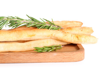 Wooden board with tasty Italian Grissini on white background, closeup