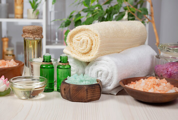 Spa treatment with candles and towel on wooden table, closeup