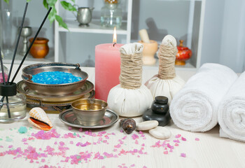 Spa items are arranged in a composition on a table.