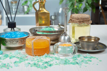 Spa items are arranged in a composition on a table.
