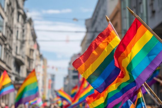 A vibrant parade of pride flags celebrates love and equality within a bustling city street.