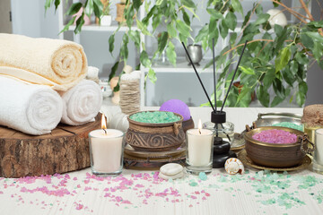 Spa items are arranged in a composition on a table.