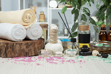 Spa massage items are arranged in a composition on the table.