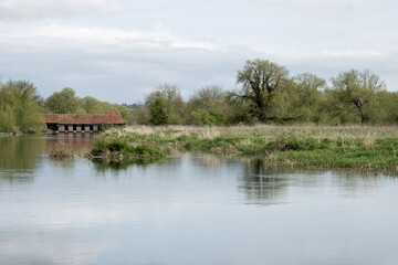 Fototapeta premium view of the sluice house and eel trap on the River Avon from Churchill Gardens Salisbury Wiltshire England