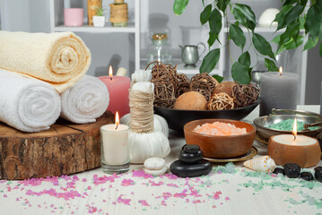 Spa items are arranged in a composition on a table.
