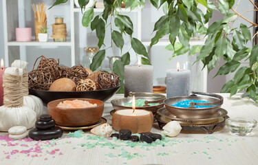 Spa treatment with candles and towel on wooden table, closeup