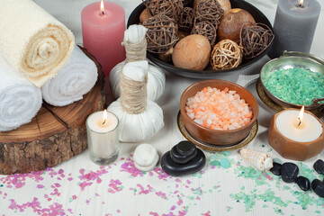 Spa treatment with candles and towel on wooden table, closeup