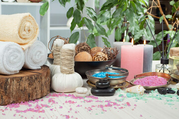 Spa items are arranged in a composition on a table.