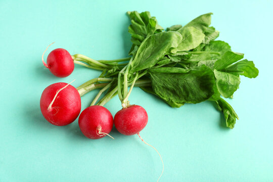 Fresh radishes with leaves on blue background - Powered by Adobe