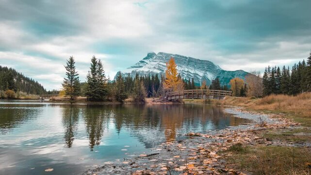 Cascade ponds with mount rundle, wooden bridge and cloudy sky in autumn at Banff national park, Canada