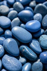 a close up of a pile of blue rocks with a small stone in the middle
