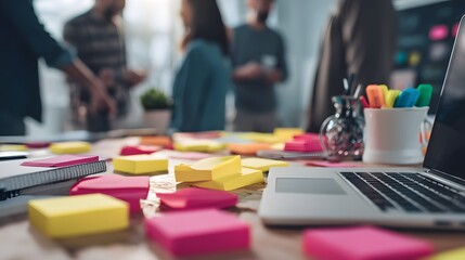 Brainstorming Team Meeting: A modern collaborative workspace where team members gather around a table strewn with vibrant sticky notes and a laptop, capturing the essence of teamwork, innovation.