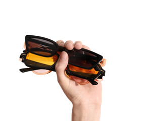Female hand holding different sunglasses on light background