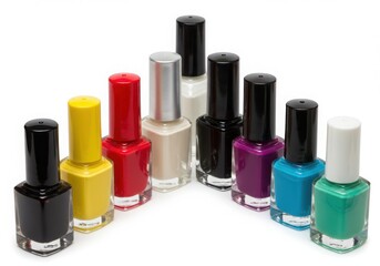 Obraz premium Assortment of colorful nail polish bottles on a white surface isoleted on white background