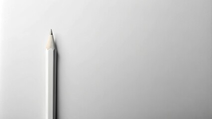 A single white pencil rests on a pristine white surface, ready for creative expression and artistic endeavors