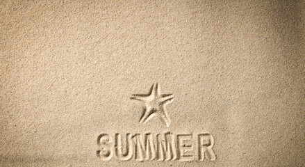 Starfish and summer writing on the sand with copy space for a product. Sandy background and beach in summer.