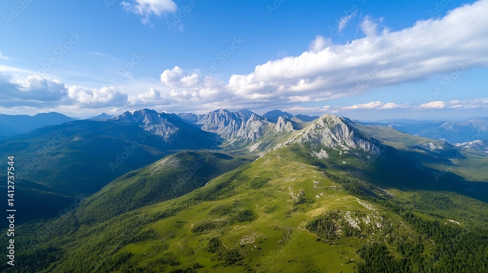 Aufkleber aerial view of majestic mountains with lush greenery under a bright blue sky with fluffy clouds : ge