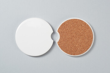 Two car cup holder coasters. Top view of ceramic coaters on isolated background. Blank coasters with cork basis mockup