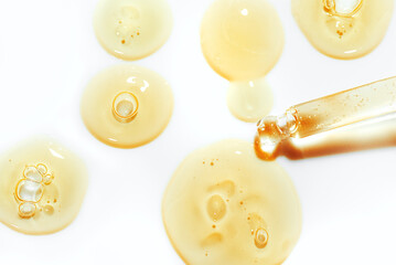 Drops of retinol cosmetic serum and pipette