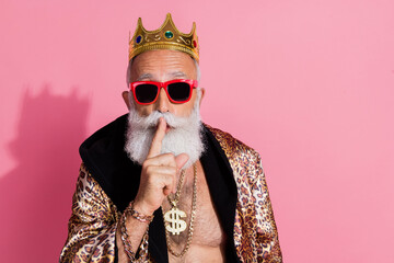 Photo of attractive grandpa king keep secret gesture dressed stylish leopard print garment isolated...