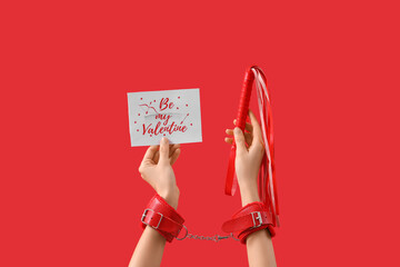 Woman holding card with sex toys on red background. Valentine's Day celebration