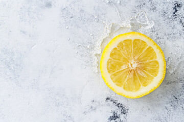 Sliced lemon with water splash on light background