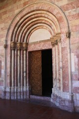 Ancient wooden gates near the stone nave.