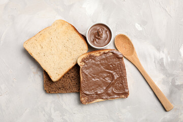 Toasts with sweet chocolate spread on grey background