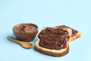 Toasts with sweet chocolate spread on blue background