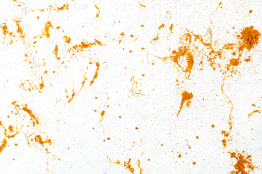 Turmeric powder scattered lightly on a seamless white background, ideal for food styling.