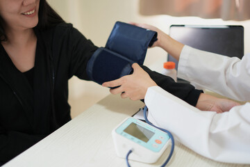 An asian young doctor is consulting about symptom problem and reporting the health examination results and recommend medication and treatment to female patient, a kind of medical checkup concept.