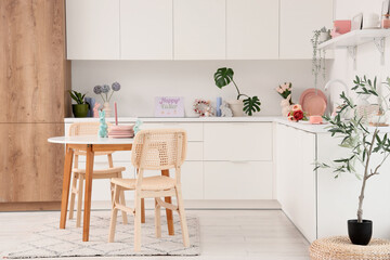 Interior of kitchen decorated for Easter with dining table and counters