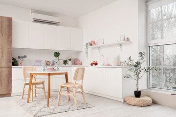 Interior of kitchen decorated for Easter with dining table and counters