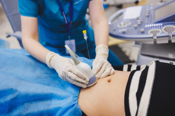 Shot of a pregnant woman during an ultrasound scan in a fertility clinic. Examination healthcare pregnancy gynecology people professionalism trust
