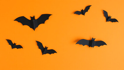 Fototapeta premium Delicate Handcut Black Paper Bats on Orange Background Halloween Decorations