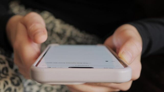 Woman creates workout plan using artificial intelligence AI in an application, close-up. Working with GPT chat app online on mobile phone, modern technology, freelance, digital assistant.