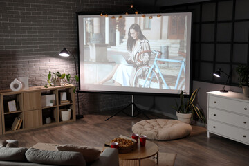 Interior of dark room with video projector screen. Home cinema