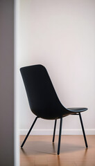 black chair sitting on top of a hard wood floor