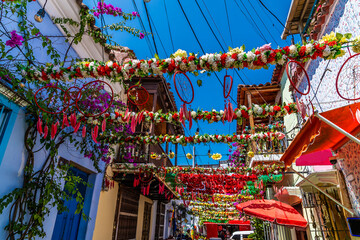 A view up a garland decorated backstreet in the Getsemani district of Cartagena, Columbia in springtime