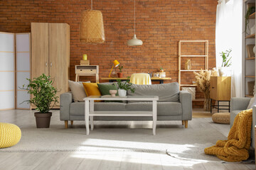 Interior of studio apartment with sofa and workplace