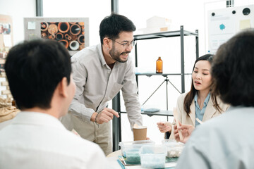 Fototapeta premium Creative Team Brainstorming Ideas in the Office, Woman and Man Collaborating in Professional Business Meeting, Fostering Teamwork Discussion for Successful Startup, Working Together in Workplace