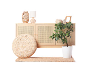 Chest of drawers with pouf and plant on white background