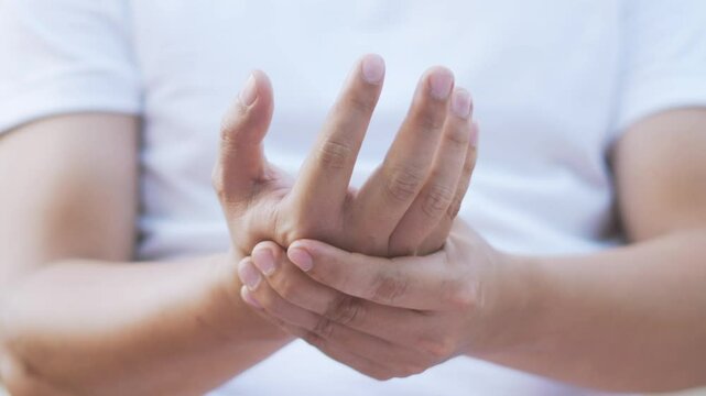 Closeup man holds his wrist. hand injury, feeling pain. Health care and medical concept. and those with a family history of degenerative knuckles.